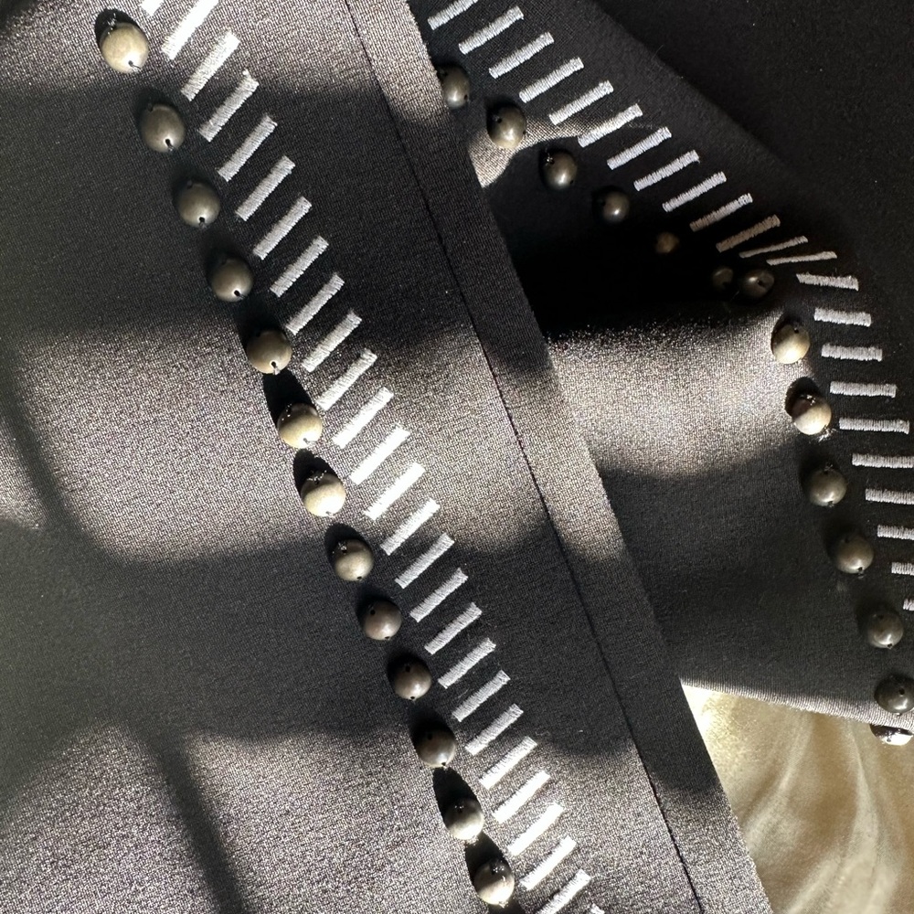 Brand new! Black with a side, stitching, and studs! Very flattering on!